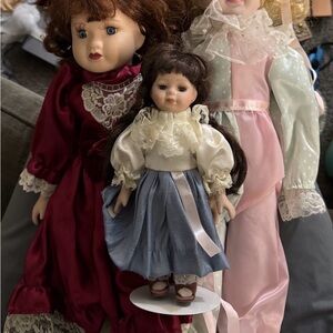 Elegant Porcelain Doll Set with Burgundy, Pink, and Blue Dresses